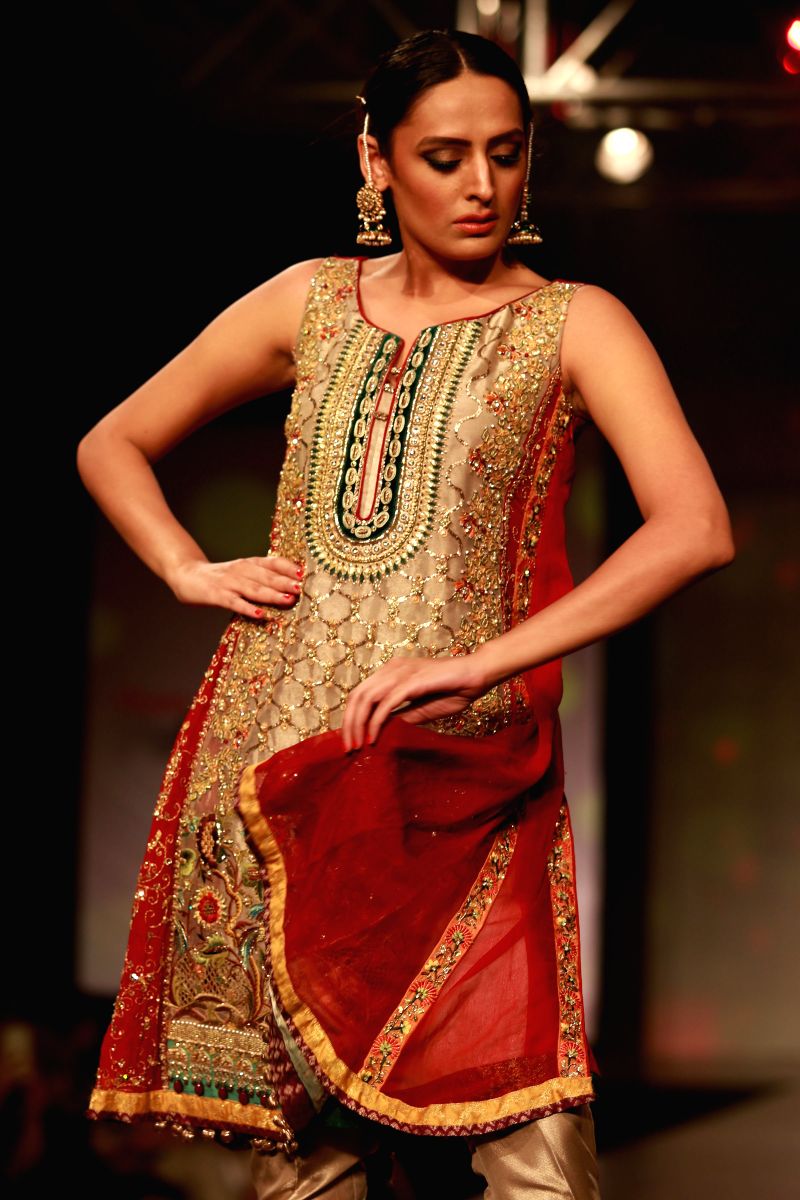 A model walks the ramp during Shaan-e-Pakistan 2015 - a fashion show where Indian as well as Pakistani designers showcased their creations in New Delhi, on Sep 13, 2015.