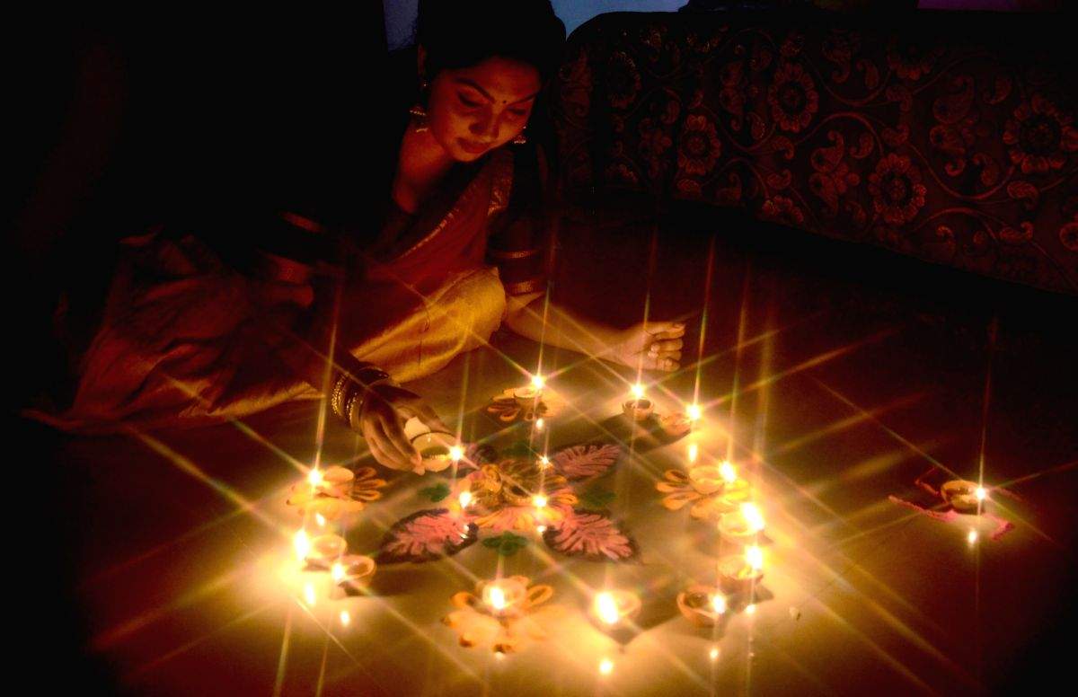 Earthen lamps and Rangoli during Diwali