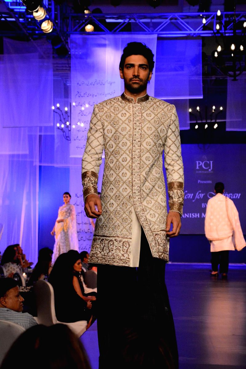 Model displays the creations of fashion designer Manish Malhotra during `Men for Mijwan` at Grand Hyatt in Mumbai, on April 1, 2014.